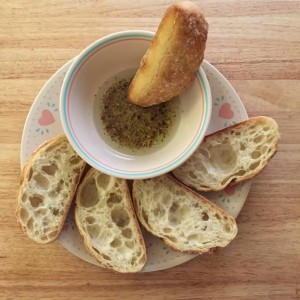 olive oil bread dip plate garlic and herb red pepper ciabatta loaf