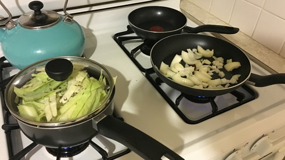 Debbie cooking cabbage and onions